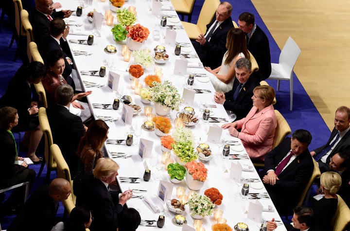 German Chancellor Angela Merkel (c-R) flanked by (from L) Russia's President Vladimir Putin, US First Lady Melania Trump, Argentinia's President Mauricio Macri and China's President Xi Jinping attends the banquet after a concert at the Elbphilharmonie concert hall during the G20 Summit in Hamburg, Germany, on July 7, 2017.