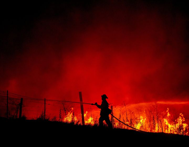 A firefighter battles flames as the Detwiler fire rages near the town of Mariposa, California on Tuesday. 