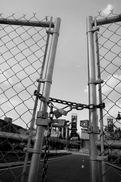 Locked gate at closed steel mill.