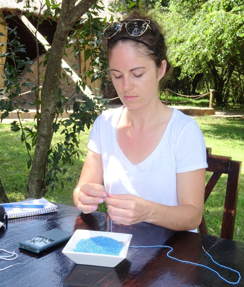 <em>Katie Rees stringing beads</em>