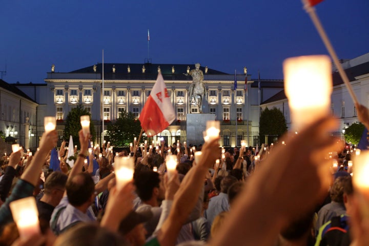Protesters gather in front of the Presidential Palace during a peaceful protest against the judicial reforms in Warsaw, Polan