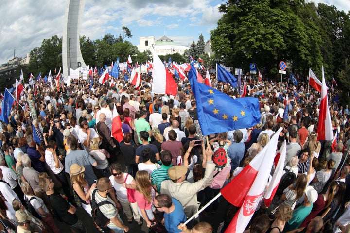 Protesters gather Tuesday in front of the Parliament building during an opposition protest in Warsaw, Poland.