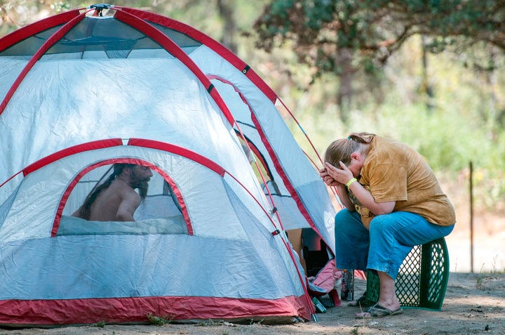 Detwiler Fire evacuees who declined to give their names react to their situation while camping at a Red Cross evacuation center in Oakhurst, California, on July 19.