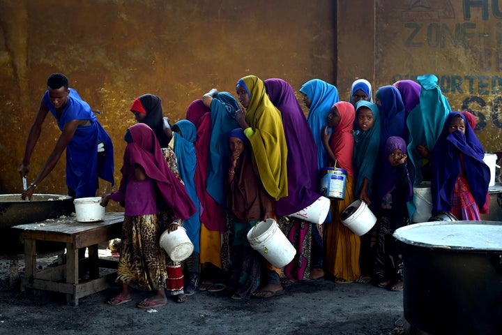 <p>Young girls line up at a feeding center in Mogadishu.</p>