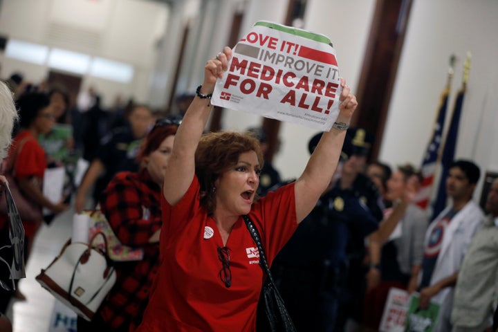 A health care activist affiliated with the National Nurses United labor union protests the Republican health care bill on Wednesday.