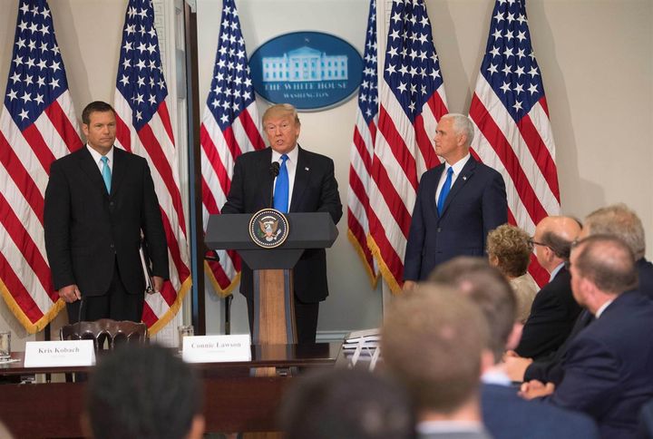 Trump speaks alongside Kansas Secretary of State Kris Kobach, left, and Vice President Mike Pence during the first meeting of the Presidential Advisory Commission on Election Integrity in the Eisenhower Executive Office Building next to the White House in Washington on July 19, 2017. 
