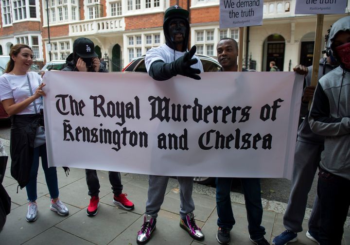 People protest ahead of a meeting of Kensington and Chelsea Council at Kensington Town Hall in west London