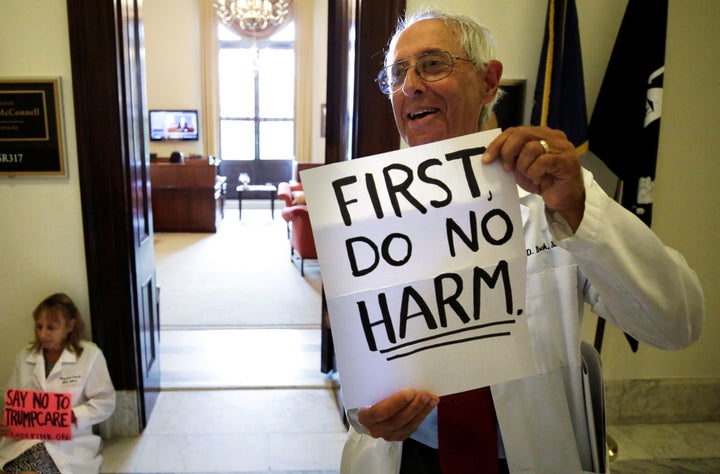 Health care activists make themselves comfortable outside of Senate Majority Leader Mitch McConnell's office, in protest of the GOP's efforts to repeal the Affordable Care Act.