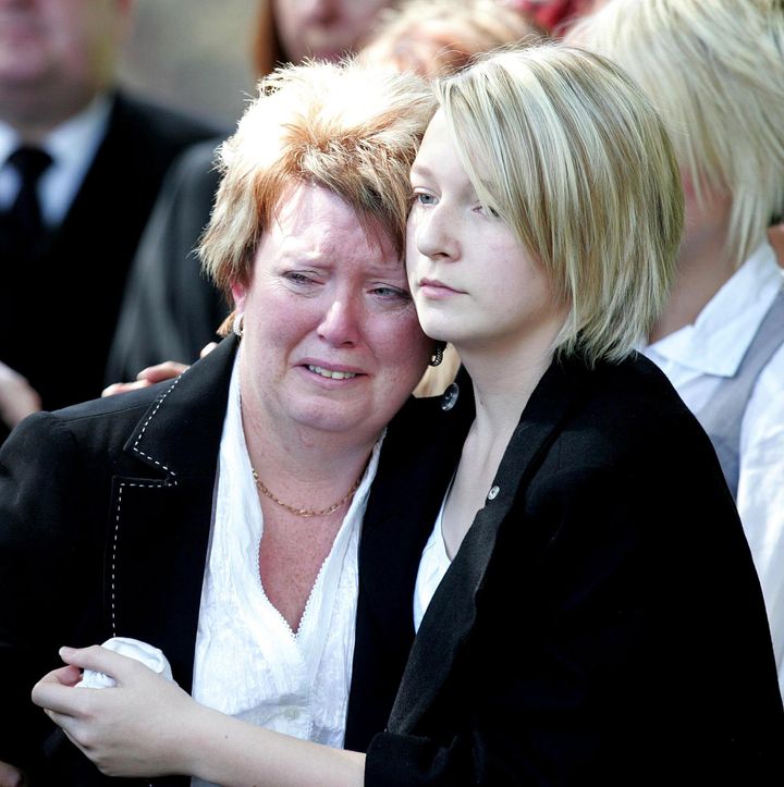 Baroness Newlove is comforted by her daughter Danielle at the funeral of her husband Gary