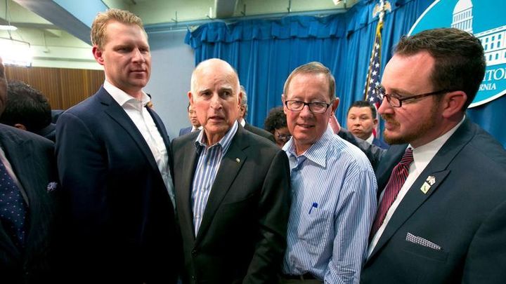 Jerry Brown with a rather tall California Assembly Republican Leader Chad Mayes and other Republican legislators who voted for Brown’s climate change legislation.