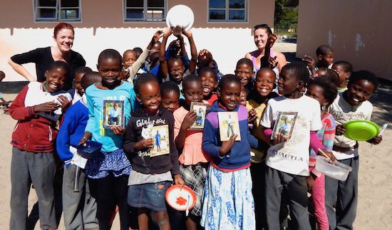 <p>Bobbie Rich (back left) in Botswana, Africa with her sister (back right) Lindsey Rich, who created a nonprofit to expose local children to wildlife and shed a positive light on the animals in Botswana. Bobbie Rich collaborated with her sister and with the Santa Monica community to create frames to give local Botswana kids treasured photos of themselves. </p>