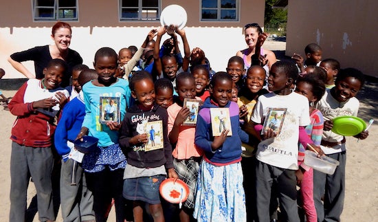 Bobbie Rich (back left) in Botswana, Africa with her sister (back right) Lindsey Rich, who created a nonprofit to expose local children to wildlife and shed a positive light on the animals in Botswana. Bobbie Rich collaborated with her sister and with the Santa Monica community to create frames to give local Botswana kids treasured photos of themselves. 