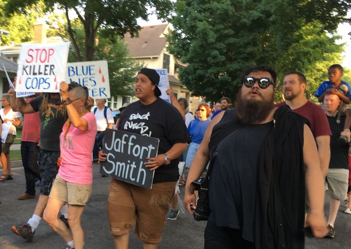Black Lives Matter activist Chauntyll Allen (center) chants "No justice, no peace" alongside members of the Minneapolis community.