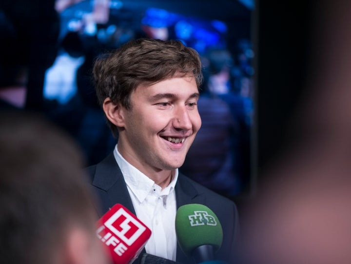 A cheerful Sergey Karjakin is interviewed after the first game