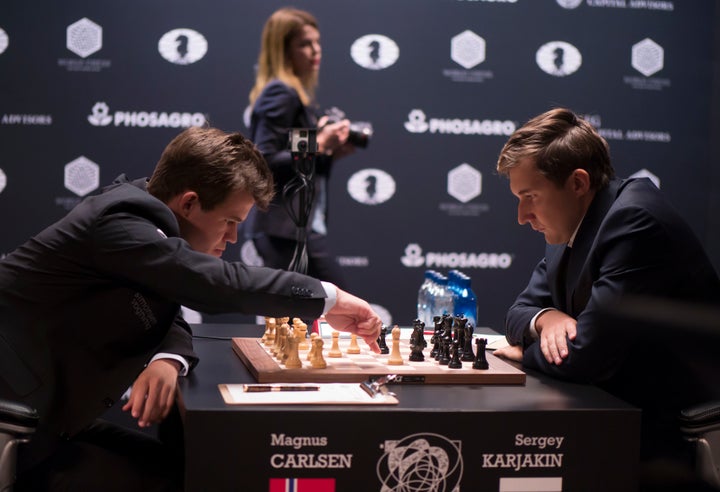 Russian chess grandmasters Boris Spassky, right, and Anatoly Karpov, left,  shake hands the news