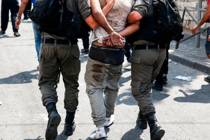 Israeli security forces detain a Palestinian protester during clashes following prayers outside Jerusalem's Old City on July 21, 2017.