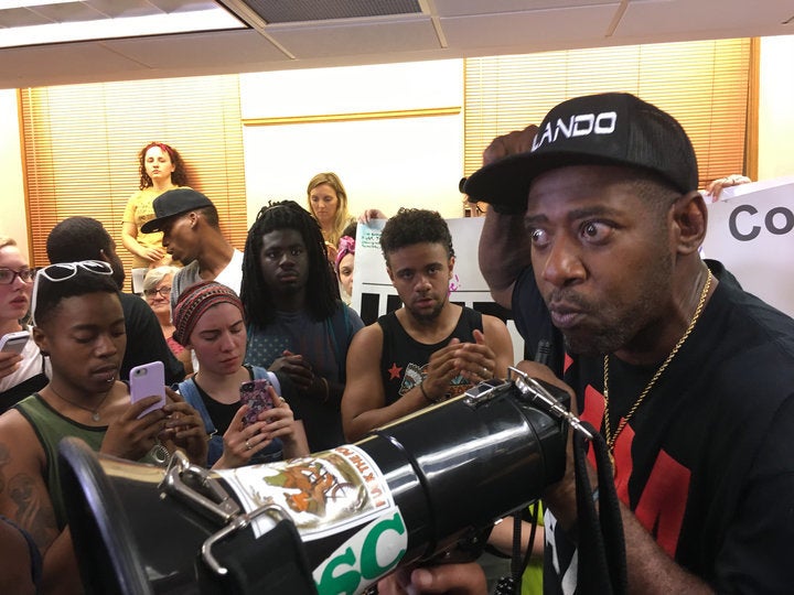 John Thompson addresses protesters after the crowd overtook Mayor Betsy Hodges' press conference on Friday.