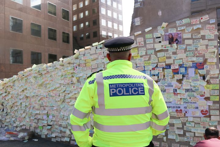 A list of 173 suspected Islamic State fighters - possibly trained to bomb and launch suicide attacks in Europe - has been circulated by Interpol - a policeman stands in front of a wall covered with messages of condolence in the wake of the London Bridge terror attack