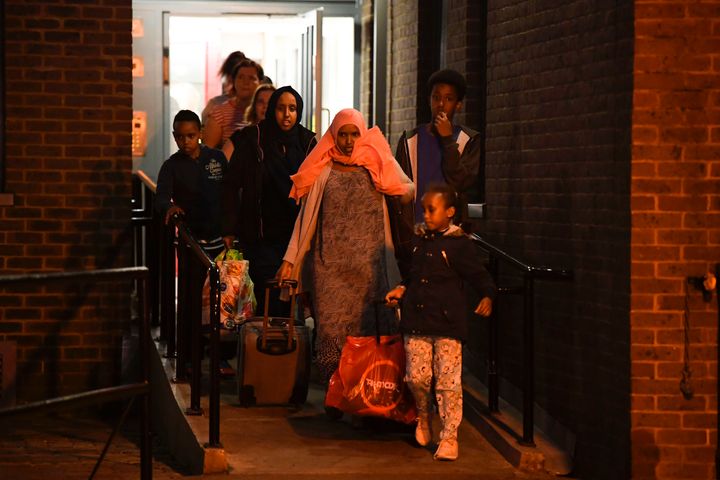The majority of residents evacuated from north London's Chalcots estate have returned to their homes; tenants are seen above evacuating the Camden towers on June 23