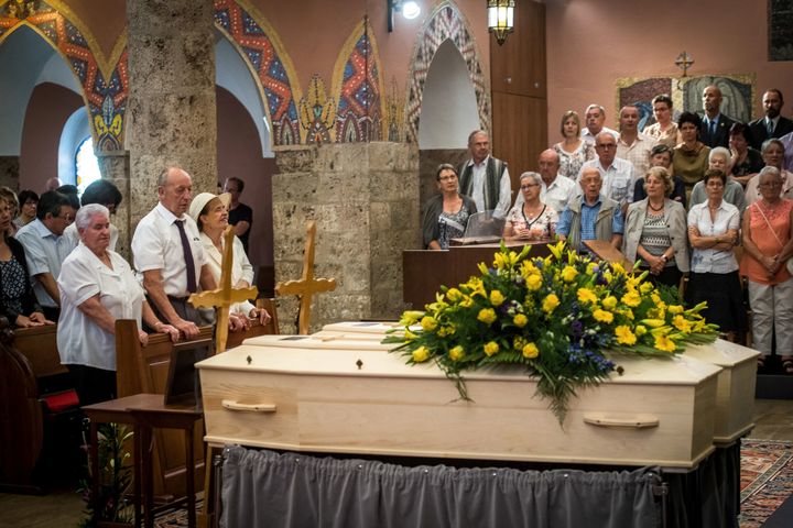 The late couple's daughter, Marcelline Udry, seen third from left, attends her parents' funeral ceremony in Saviese, Switzerland, on Saturday.