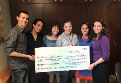 Students in the food insecurity group presenting their donation to a representative from Hunger Free America (far right).
