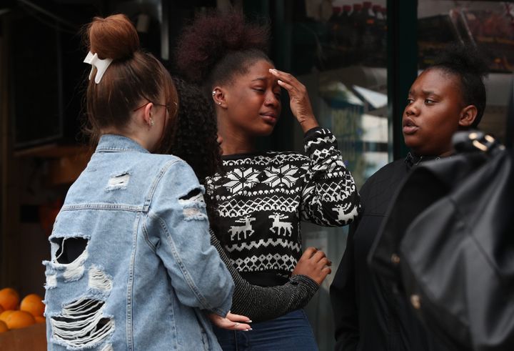 People react outside a shop in Kingsland Road, east London.