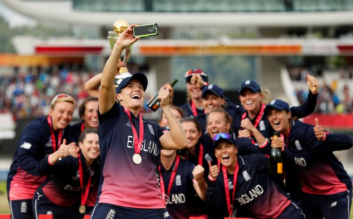 England's Katherine Brunt celebrates winning the World Cup by taking a selfie with team-mates.