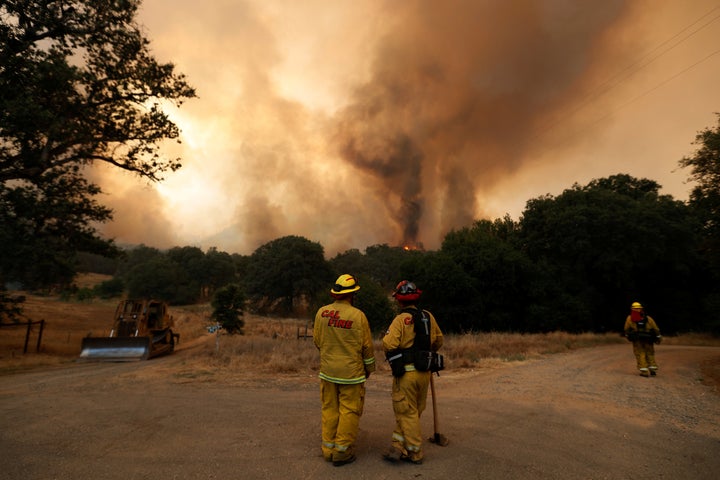 CalFire firefighters monitor flames from the Detwiler fire on July 19.