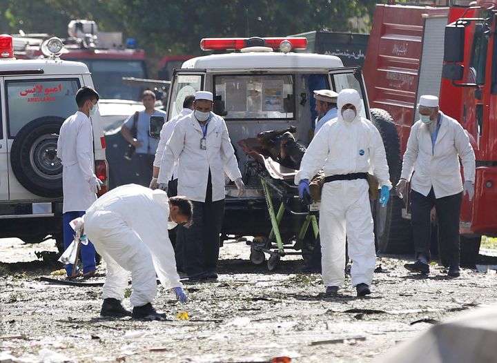 Afghan investigators work at the site of a suicide attack in Kabul on Monday.