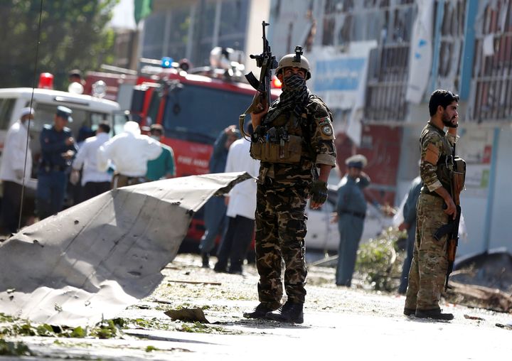 Afghan security forces keep watch at the site of a suicide bombing in Kabul on Tuesday. The Taliban later claimed responsibility for the attack.
