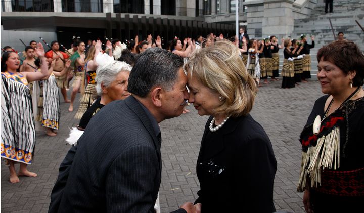 Former US Secretary of State Hillary Clinton hongis with Maori elder Lewis Moeau in 2010