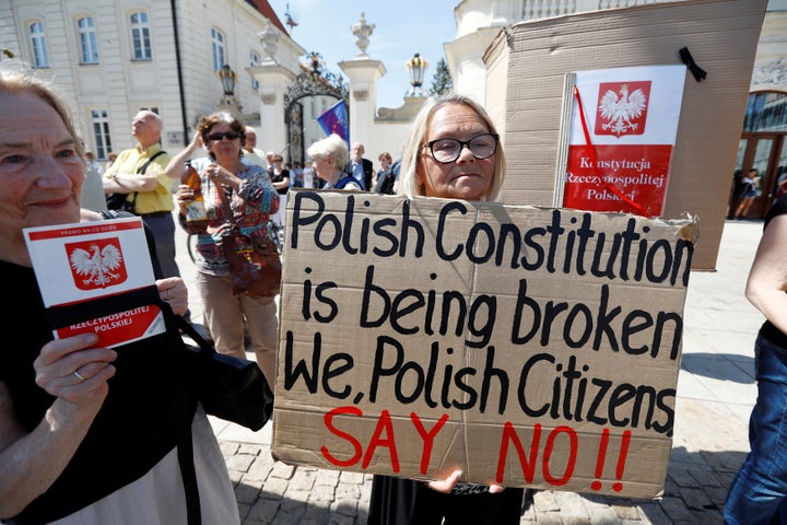 People gather in front of the Presidential Palace during a Sunday protest against the Supreme Court legislation in Warsaw, Po