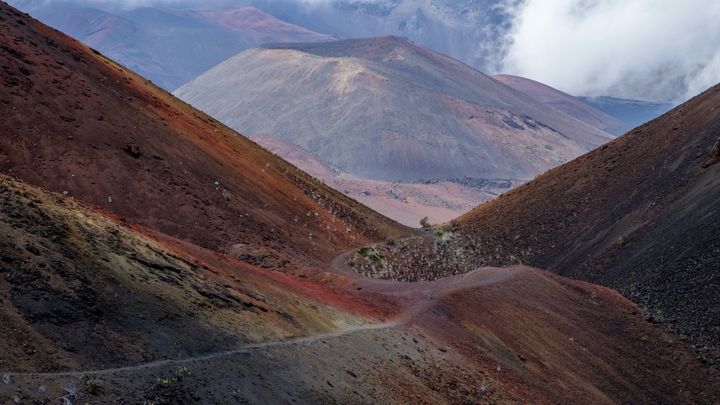 Surreal terrain washed with rich color on the cinder-cone landscape of the Haleakala Crater.