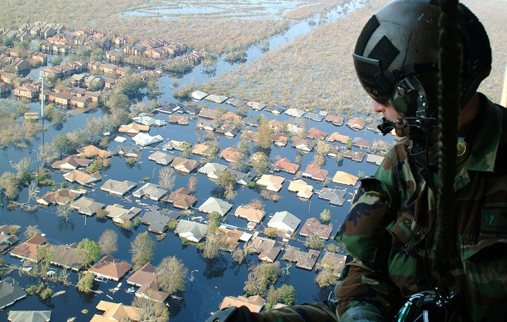 Tech. Sgt. Keith Berry looks down into New Orleans’ flooded streets searching for survivors. 