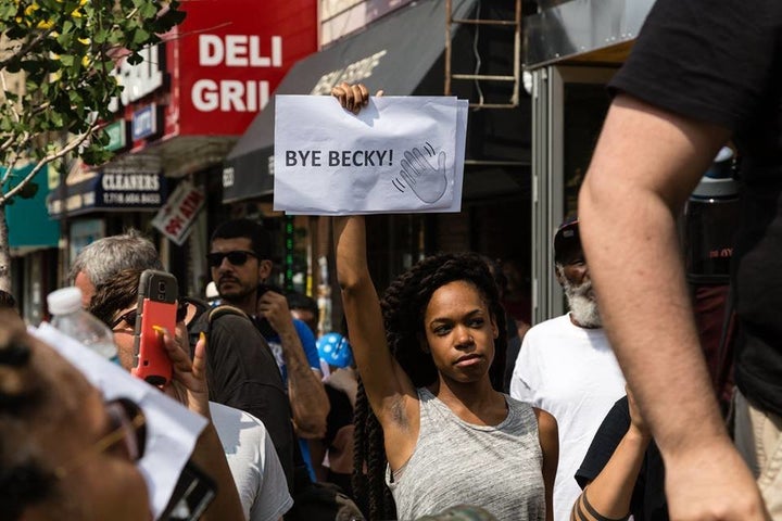 Organizer Justine Stephens holds up a sign that reads "Bye, Becky!"