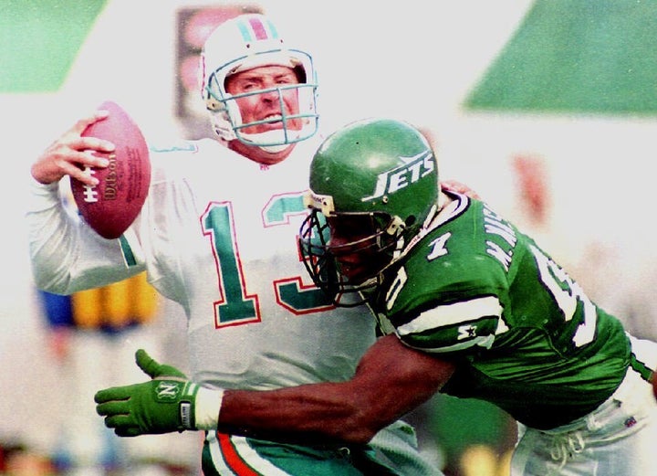 In this file photo from November 1992, New York Jets player Marvin Washington sacks Miami Dolphins quarterback Dan Marino.