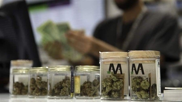 A cashier rings up a marijuana sale in Nevada. The state began selling recreational marijuana July 1, six months ahead of sch