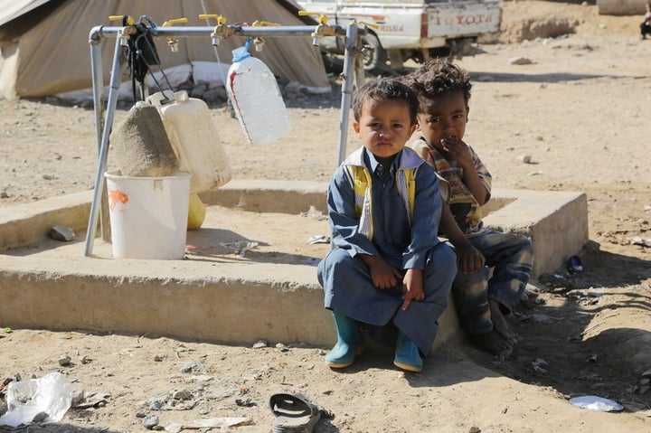 Sultan*, 3 years old and Sabir*, 3 years old sitting by a tap stand in the Huth camp for displaced people in Yemen. Oxfam has been working in the camp since late 2015, providing humanitarian assistance to displaced people with safe drinking water and other lifesaving humanitarian aid. *Names have been changed