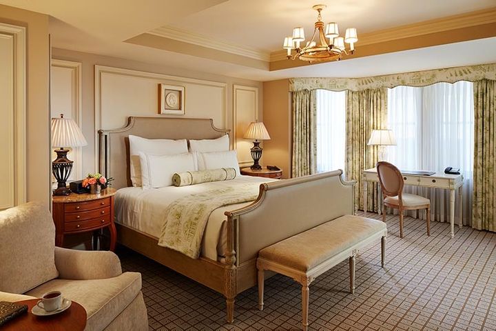 A deluxe king guest room features bow window with spacious footprint and artful design.