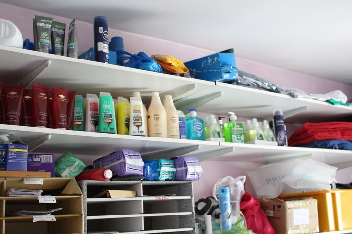 Packs of toiletries supplied by In Kind Direct line the walls of a charity's office in London