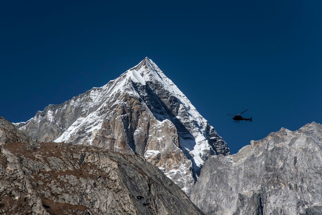 An Indian Army helicopter flies over a peak in the Western Himalayas. Oct. 12, 2016.
