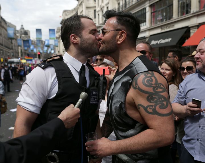 A policeman kisses his boyfriend after proposing to him during the Pride in London parade this year
