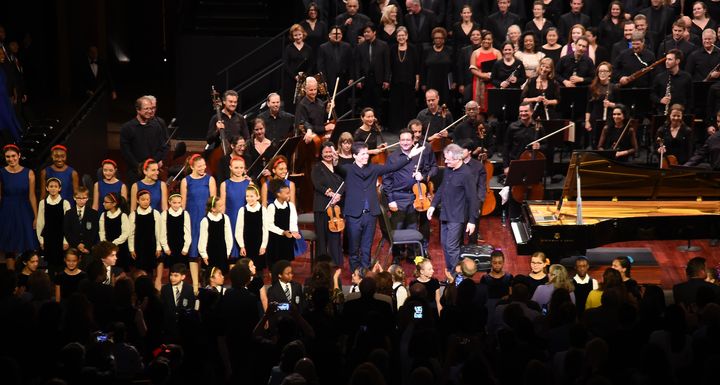 Kit Armstrong and conductor Louis Langree are seen during curtain call with the Mostly Mozart Festival Orchestra, Concert Chorale of New York and the Young People's Chorus of New York City 