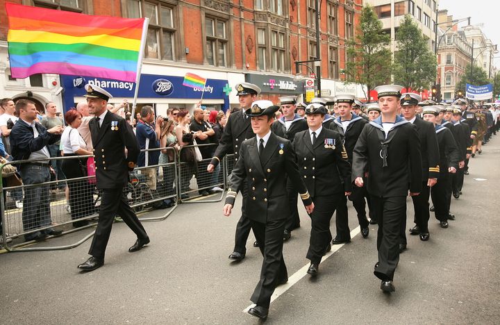 Military personnel take part in the Pride parade.
