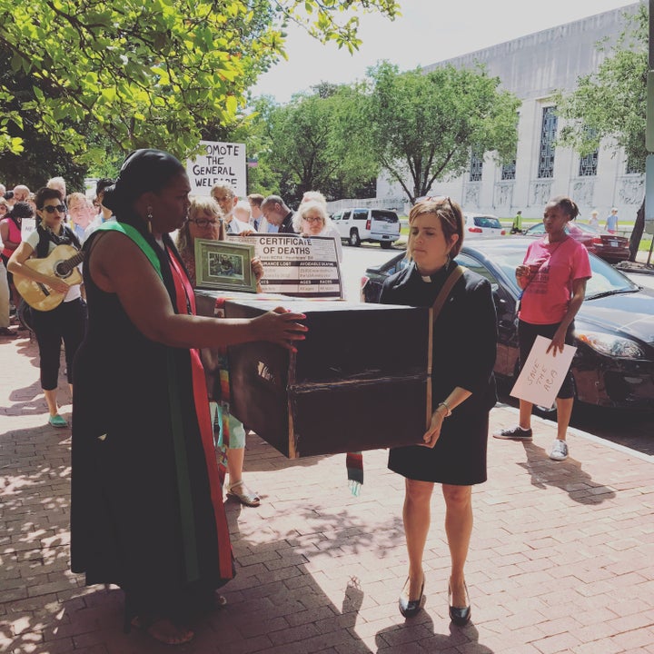 Faith leaders carry a coffin during a protest on Capitol Hill against efforts to repeal Obamacare.