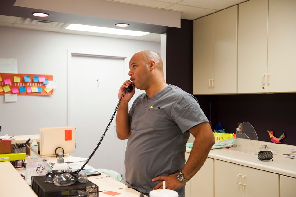 Dalton Johnson, who owns the Huntsville clinic, takes a call from a prospective client and explains the state's waiting period laws.