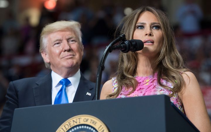 President Donald Trump looks on as first lady Melania Trump speaks at a rally in Youngstown, Ohio, on July 25, 2017.