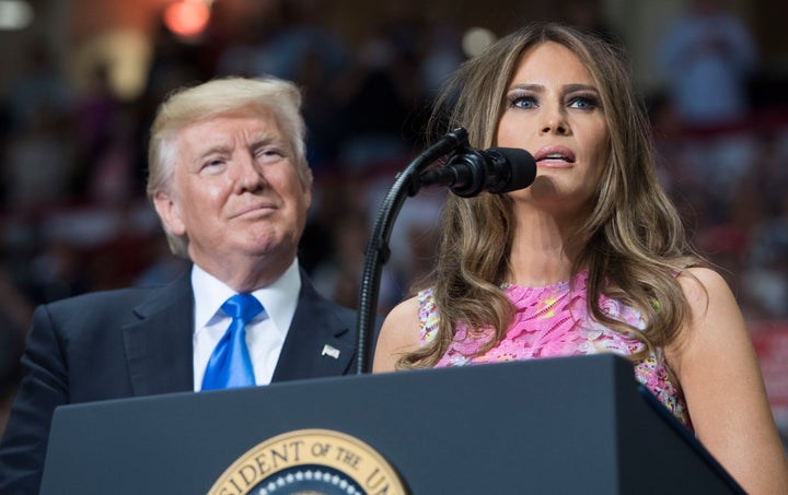 President Donald Trump looks on as first lady Melania Trump speaks at a rally in Youngstown, Ohio, on July 25, 2017.