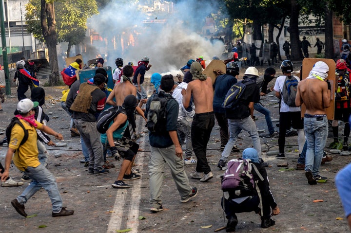 Opposition demonstrators skirmish with riot police after an anti-government protest in Caracas, Venezuela, on July 26, 2017.&