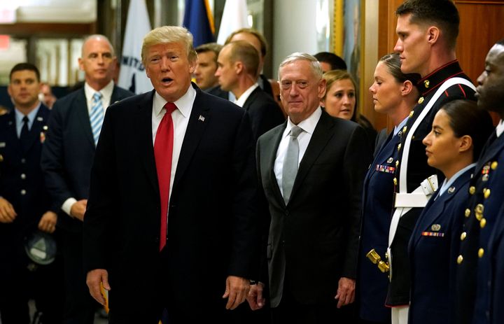 Secretary of Defense James Mattis, right, escorts President Donald Trump as he greets military personnel after attending a meeting at the Pentagon in Arlington, Virginia, on July 20.